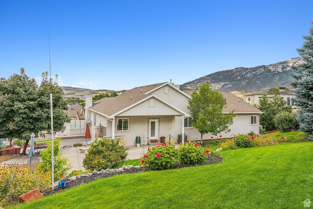 710 E Ridge Crest Ct S, Alpine, UT 84004 - view of front of property with central AC, a front yard, stucco siding, a chimney, and a mountain view