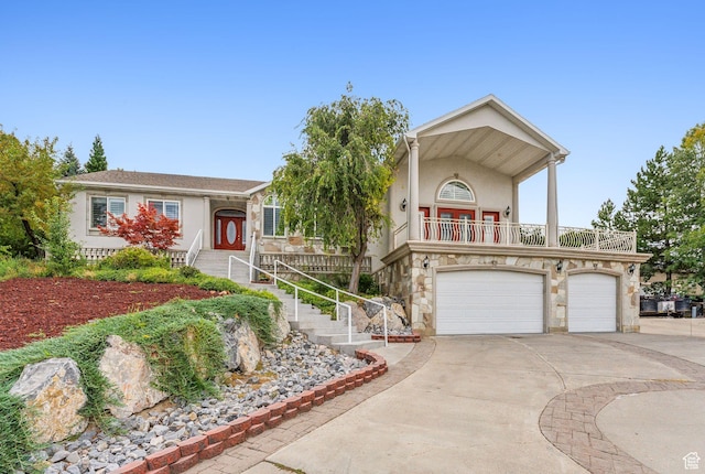 710 E Ridge Crest Ct S, Alpine, UT 84004 - view of front of house featuring a balcony, an attached garage, stucco siding, concrete driveway, and stone siding