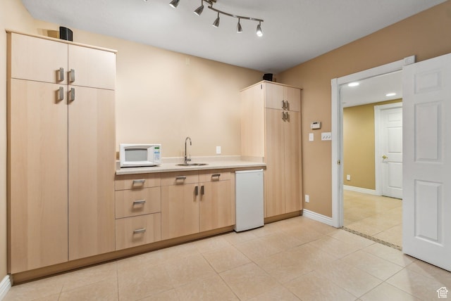 710 E Ridge Crest Ct S, Alpine, UT 84004 - kitchen with baseboards, light countertops, light tile patterned floors, white appliances, and a sink