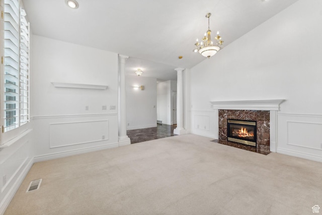 710 E Ridge Crest Ct S, Alpine, UT 84004 - unfurnished living room featuring visible vents, carpet, a decorative wall, a premium fireplace, and ornate columns