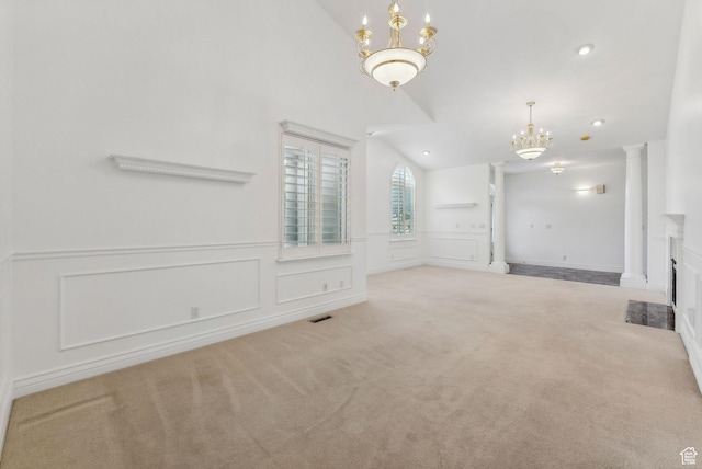 710 E Ridge Crest Ct S, Alpine, UT 84004 - unfurnished living room featuring visible vents, ornate columns, lofted ceiling, carpet flooring, and a chandelier
