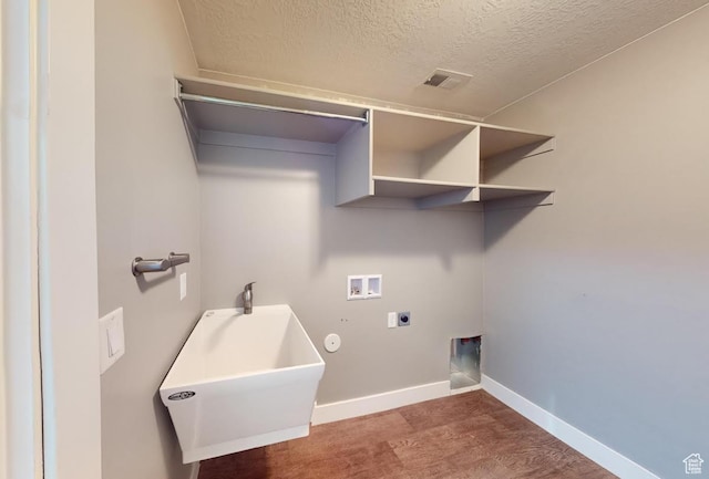 laundry room featuring electric dryer hookup, a sink, baseboards, hookup for a washing machine, and laundry area