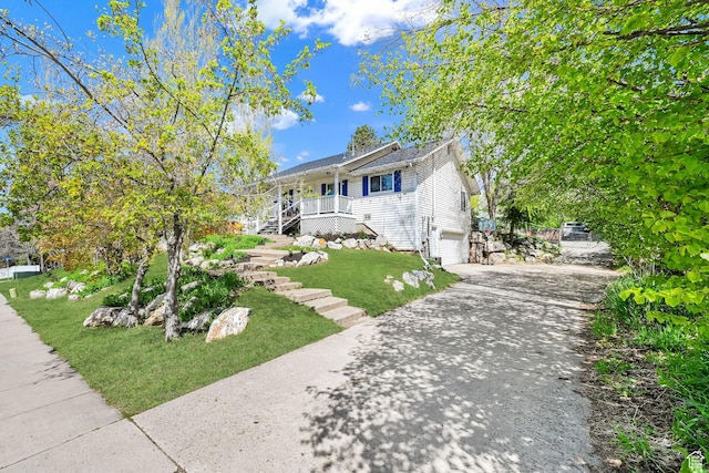 1461 E Antelope Dr, Layton, UT 84040 - bungalow-style house with covered porch, concrete driveway, an attached garage, stairway, and a front yard