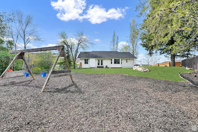 1461 E Antelope Dr, Layton, UT 84040 - back of property with a lawn, fence, and a playground