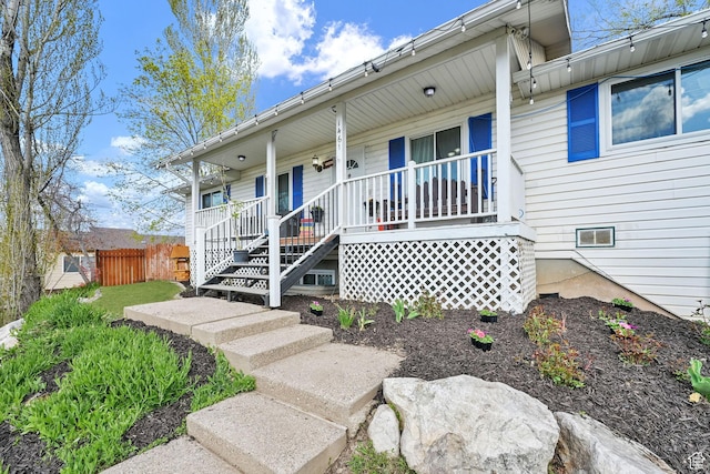 1461 E Antelope Dr, Layton, UT 84040 - doorway to property featuring fence and covered porch