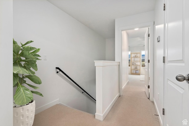 7007 W S Jordan Pkwy Unit 374, South Jordan, UT 84009 - hall with an upstairs landing, light carpet, and baseboards