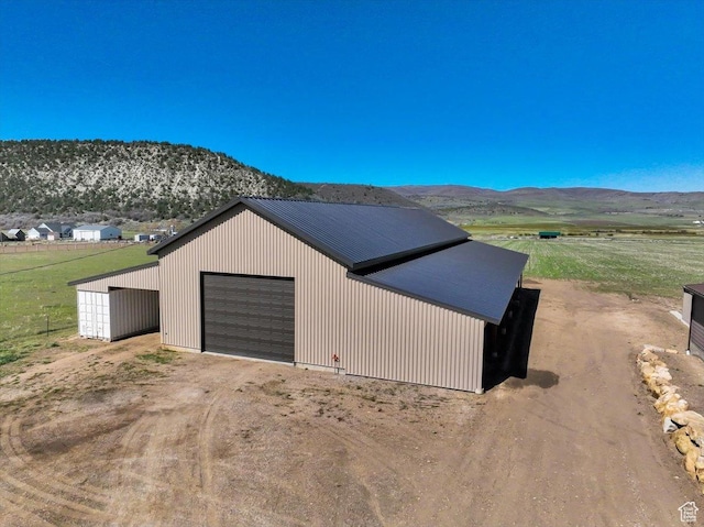 29125 N 11090 E, Fairview, UT 84629 - garage with a detached garage, dirt driveway, and a mountain view