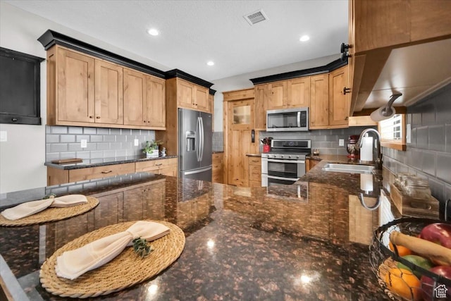 29125 N 11090 E, Fairview, UT 84629 - kitchen with a sink, dark stone countertops, visible vents, decorative backsplash, and appliances with stainless steel finishes