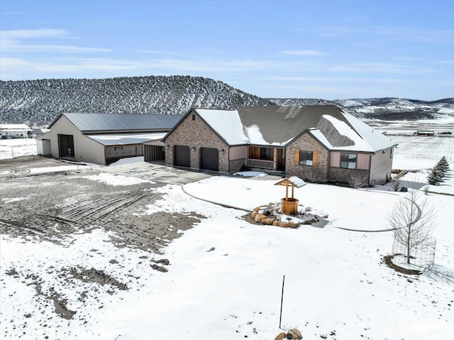 29125 N 11090 E, Fairview, UT 84629 - view of front facade featuring concrete driveway, brick siding, a garage, and a mountain view