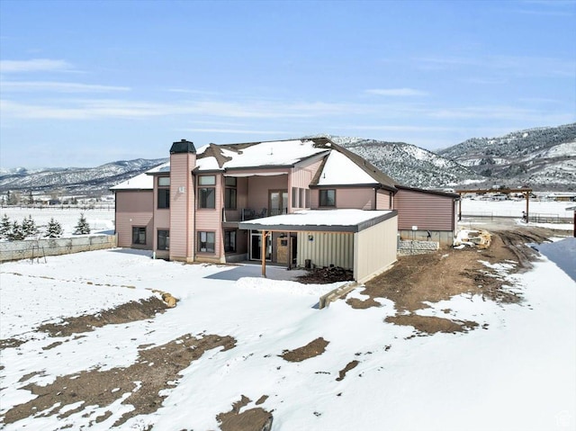 29125 N 11090 E, Fairview, UT 84629 - snow covered rear of property featuring a mountain view, a chimney, and a balcony
