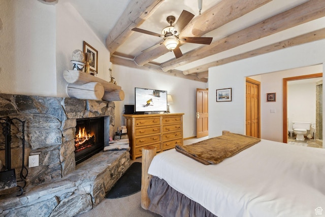 carpeted bedroom with beamed ceiling, a fireplace, and ceiling fan