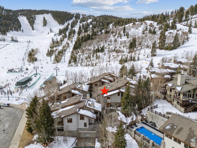 snowy aerial view featuring a residential view