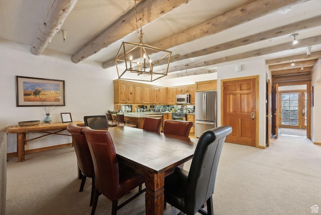 dining space with beam ceiling, a notable chandelier, light colored carpet, and baseboards