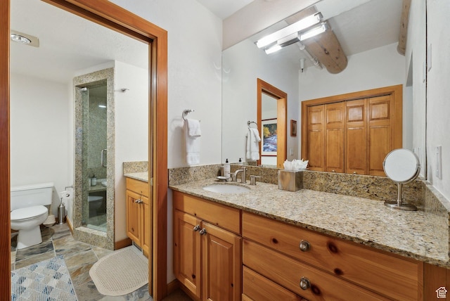 full bath featuring vanity, a shower stall, and toilet