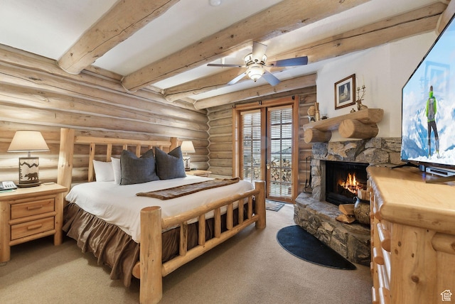 bedroom with access to exterior, beamed ceiling, light colored carpet, a stone fireplace, and rustic walls