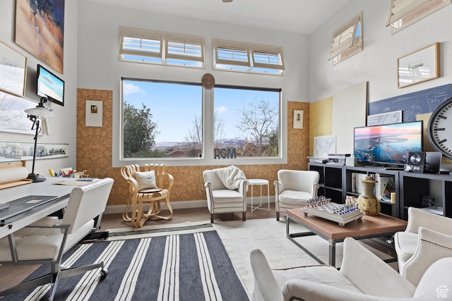 2139 W Cougar Rock Cir S Unit 135, St George, UT 84770 - living room with wallpapered walls, a towering ceiling, healthy amount of natural light, and baseboards