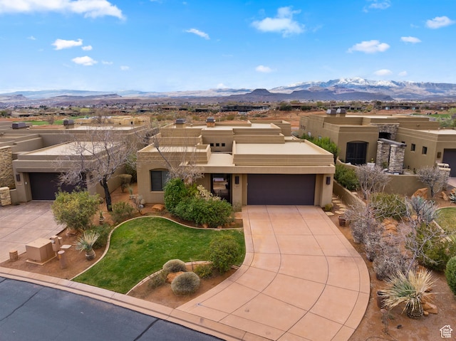 2139 W Cougar Rock Cir S Unit 135, St George, UT 84770 - pueblo-style home with a mountain view, stucco siding, an attached garage, and driveway