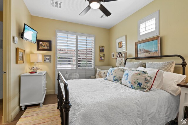 2139 W Cougar Rock Cir S Unit 135, St George, UT 84770 - bedroom featuring multiple windows, baseboards, ceiling fan, and carpet