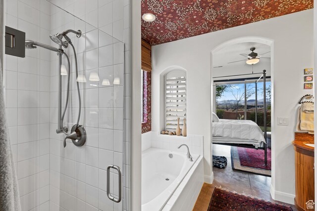 2139 W Cougar Rock Cir S Unit 135, St George, UT 84770 - ensuite bathroom featuring a shower stall, a ceiling fan, a garden tub, and baseboards