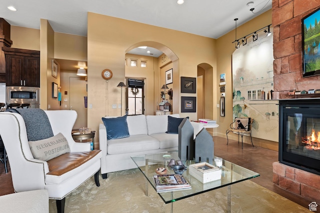 2139 W Cougar Rock Cir S Unit 135, St George, UT 84770 - living room featuring a large fireplace, arched walkways, baseboards, and recessed lighting
