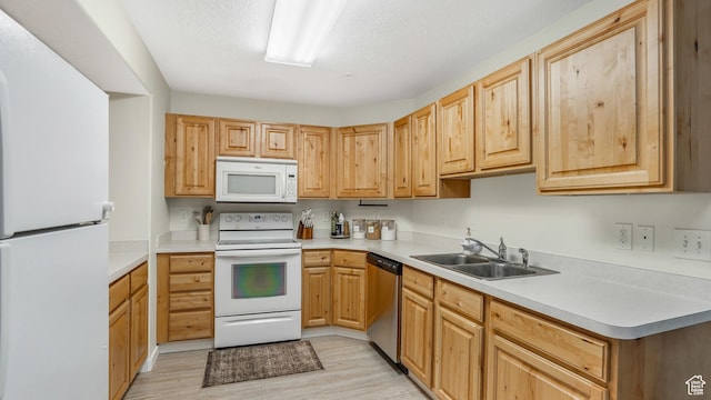 3477 E Rdg Route Rd Unit 5, Eagle Mountain, UT 84005 - kitchen with light wood finished floors, light countertops, light brown cabinets, a sink, and white appliances