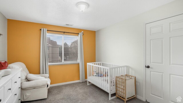 3477 E Rdg Route Rd Unit 5, Eagle Mountain, UT 84005 - bedroom with visible vents, baseboards, carpet flooring, and a nursery area