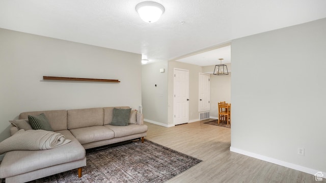 3477 E Rdg Route Rd Unit 5, Eagle Mountain, UT 84005 - living area with baseboards, visible vents, and light wood finished floors