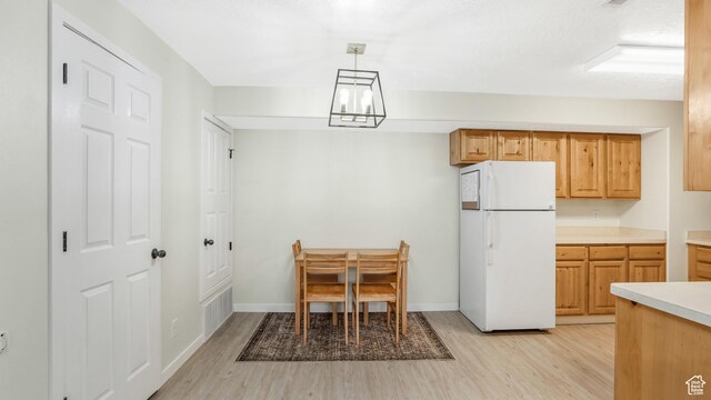 3477 E Rdg Route Rd Unit 5, Eagle Mountain, UT 84005 - dining room featuring a notable chandelier, baseboards, and light wood-style floors