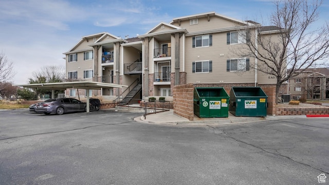3477 E Rdg Route Rd Unit 5, Eagle Mountain, UT 84005 - view of property featuring stairway and covered parking