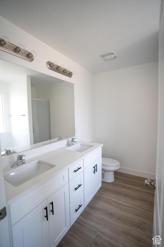 2277 E 3530 N Unit 511, Eagle Mountain, UT 84005 - full bath with a sink, toilet, wood finished floors, and double vanity