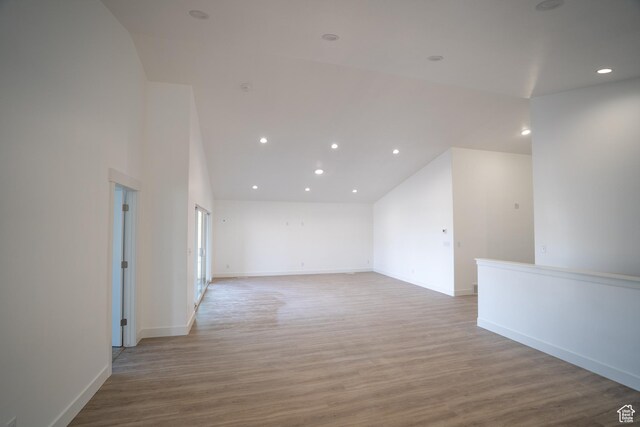 2277 E 3530 N Unit 511, Eagle Mountain, UT 84005 - empty room featuring recessed lighting, baseboards, light wood-style floors, and high vaulted ceiling