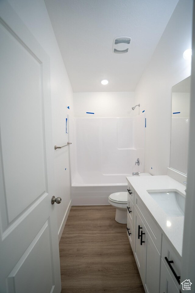 2277 E 3530 N Unit 511, Eagle Mountain, UT 84005 - bathroom featuring visible vents, toilet, wood finished floors,  shower combination, and vanity
