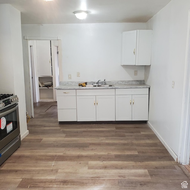 1744 W 150 N, Provo, UT 84601 - kitchen featuring light countertops, light wood-style floors, stainless steel gas stove, white cabinets, and a sink
