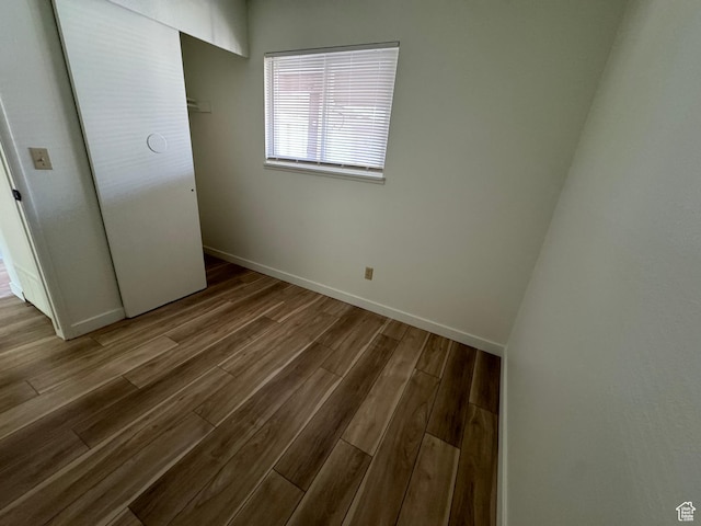 5630 S Meadow Ln Unit 197, South Ogden, UT 84403 - unfurnished bedroom featuring baseboards and wood finished floors