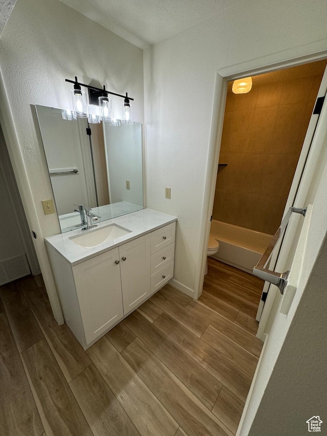 5630 S Meadow Ln Unit 197, South Ogden, UT 84403 - bathroom with toilet, vanity, baseboards, and wood finished floors