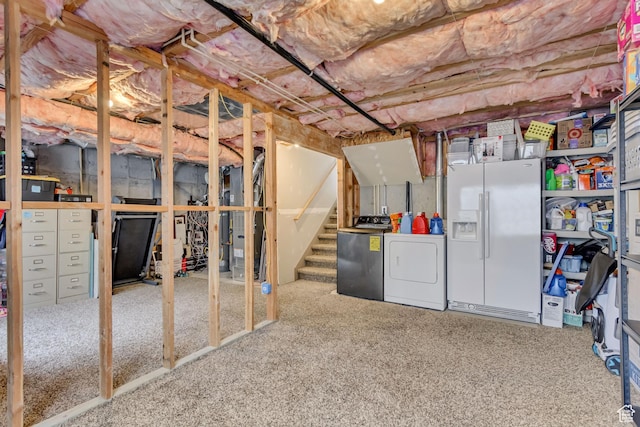 unfinished below grade area with washing machine and dryer, carpet, white refrigerator with ice dispenser, and stairs