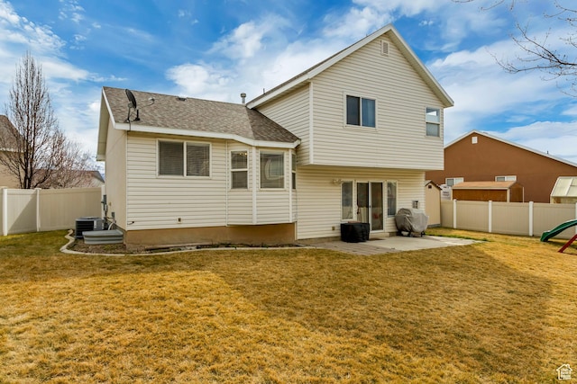 back of house with a fenced backyard, central AC unit, a yard, and a patio