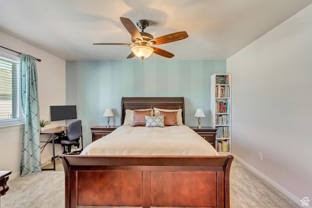 bedroom featuring ceiling fan, baseboards, and light carpet
