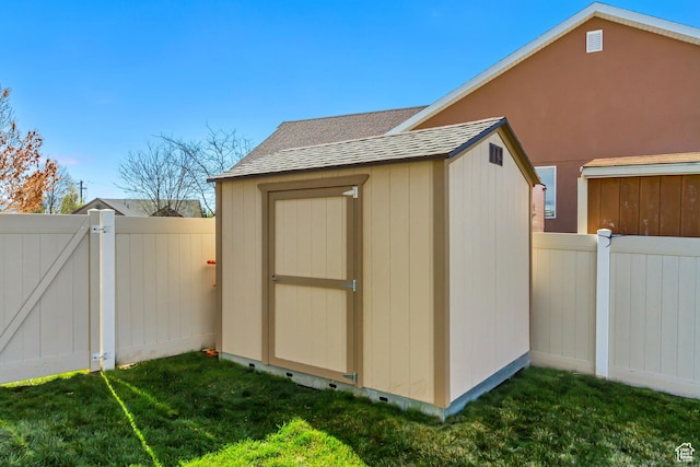 view of shed with a gate and fence
