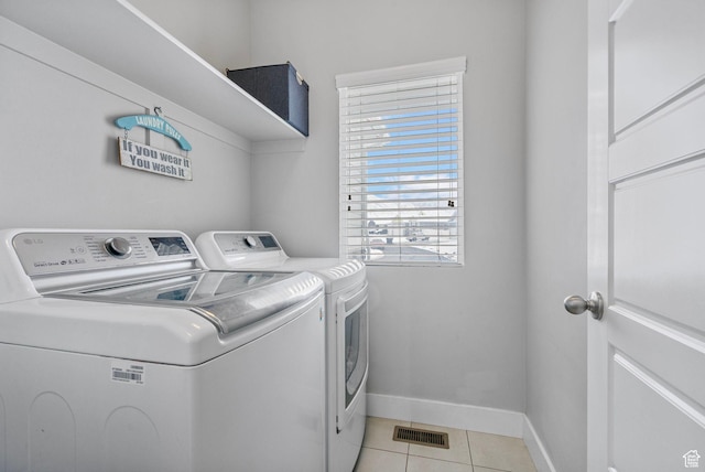 5131 N Stratford Dr W, Stansbury Park, UT 84074 - laundry room featuring visible vents, baseboards, washer and dryer, laundry area, and light tile patterned floors