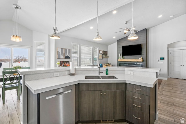 5131 N Stratford Dr W, Stansbury Park, UT 84074 - kitchen featuring stainless steel dishwasher, vaulted ceiling, a sink, open floor plan, and light wood-style flooring