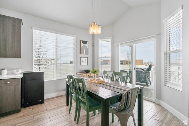 5131 N Stratford Dr W, Stansbury Park, UT 84074 - dining area with light wood finished floors, baseboards, a chandelier, and lofted ceiling
