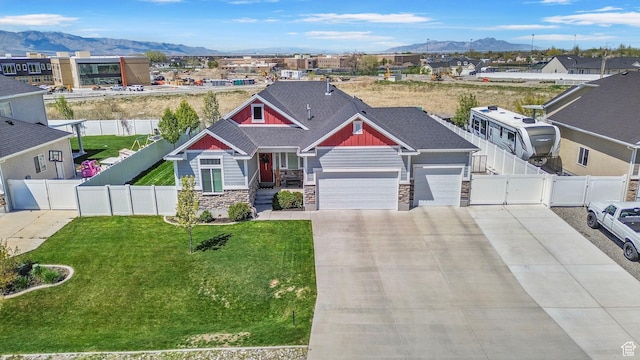 craftsman inspired home with a gate, concrete driveway, stone siding, a mountain view, and a garage