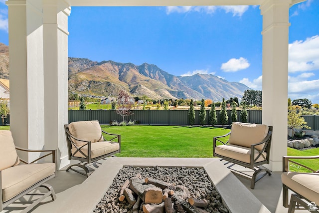 view of patio with outdoor lounge area, a fenced backyard, and a mountain view