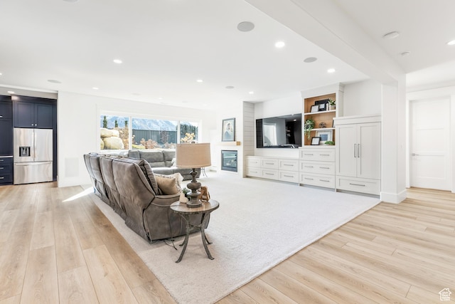living area with recessed lighting and light wood-style floors