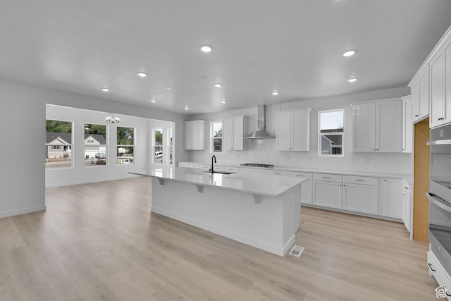1811 N 375 W Unit 8, Harrisville, UT 84404 - kitchen featuring wall chimney range hood, gas cooktop, recessed lighting, backsplash, and a kitchen island with sink
