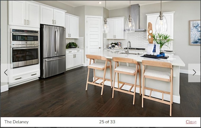 1170 N 375 W Unit 23, Harrisville, UT 84404 - kitchen featuring backsplash, wall chimney range hood, dark wood finished floors, stainless steel appliances, and a sink