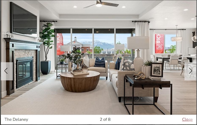 1170 N 375 W Unit 23, Harrisville, UT 84404 - living room featuring a stone fireplace, wood finished floors, a ceiling fan, and a wealth of natural light