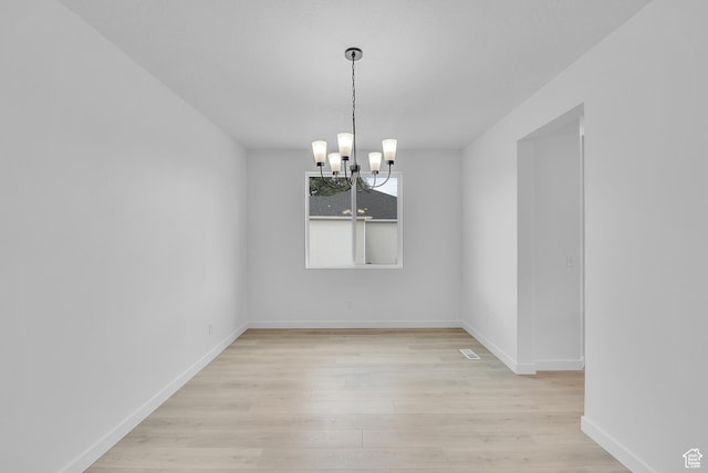 406 W 1225 N Unit 4, Harrisville, UT 84404 - spare room featuring a chandelier and light wood finished floors