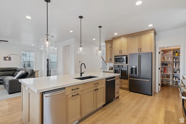 238 W Founders Blvd, Saratoga Springs, UT 84045 - kitchen with light brown cabinetry, open floor plan, light wood-style flooring, stainless steel appliances, and a sink
